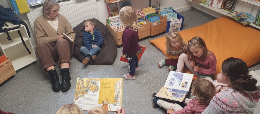 Eltern und Kinder der Krabbelgruppe Wolfenhausen sind zu Gast in der Bücherei in Laubuseschbach